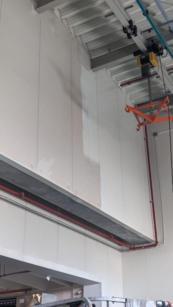 Widok na ścianę hali produkcyjnej. Czyszczenie świetlików i ścian dla firmy HELIO S.A.